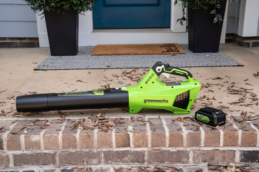 Greenworks leaf blower on brick porch