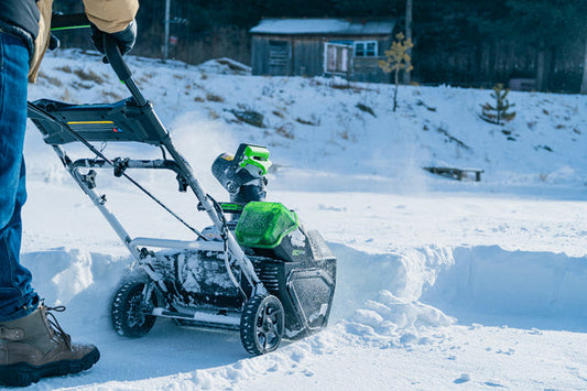 Man uisng Greenworks snow blower outside