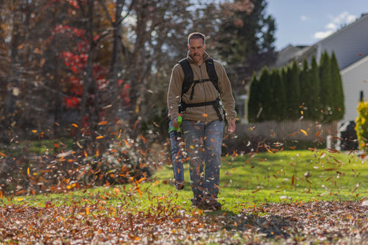Man using Greenworks backpack leaf blower.